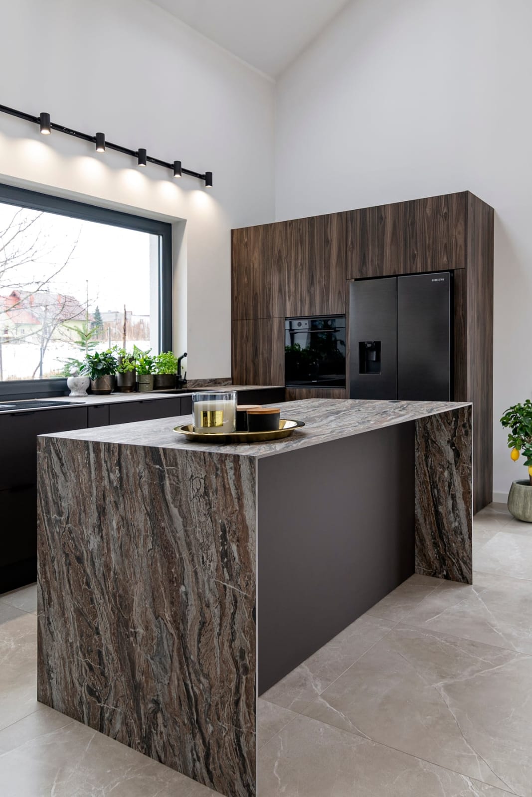 Dark walnut kitchen with marble island and integrated black appliances