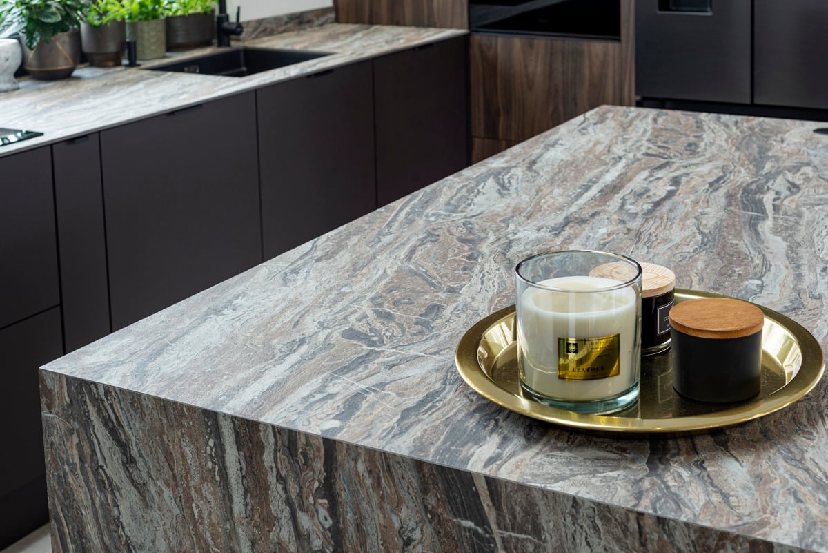 Kitchen island with dark cabinets and stone worktop