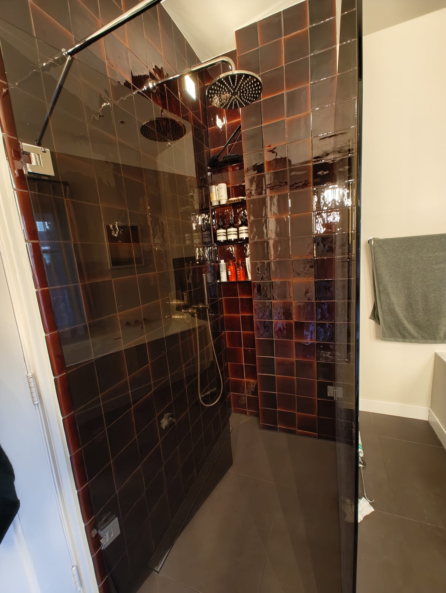 Walk-in shower with dark red glazed tiles