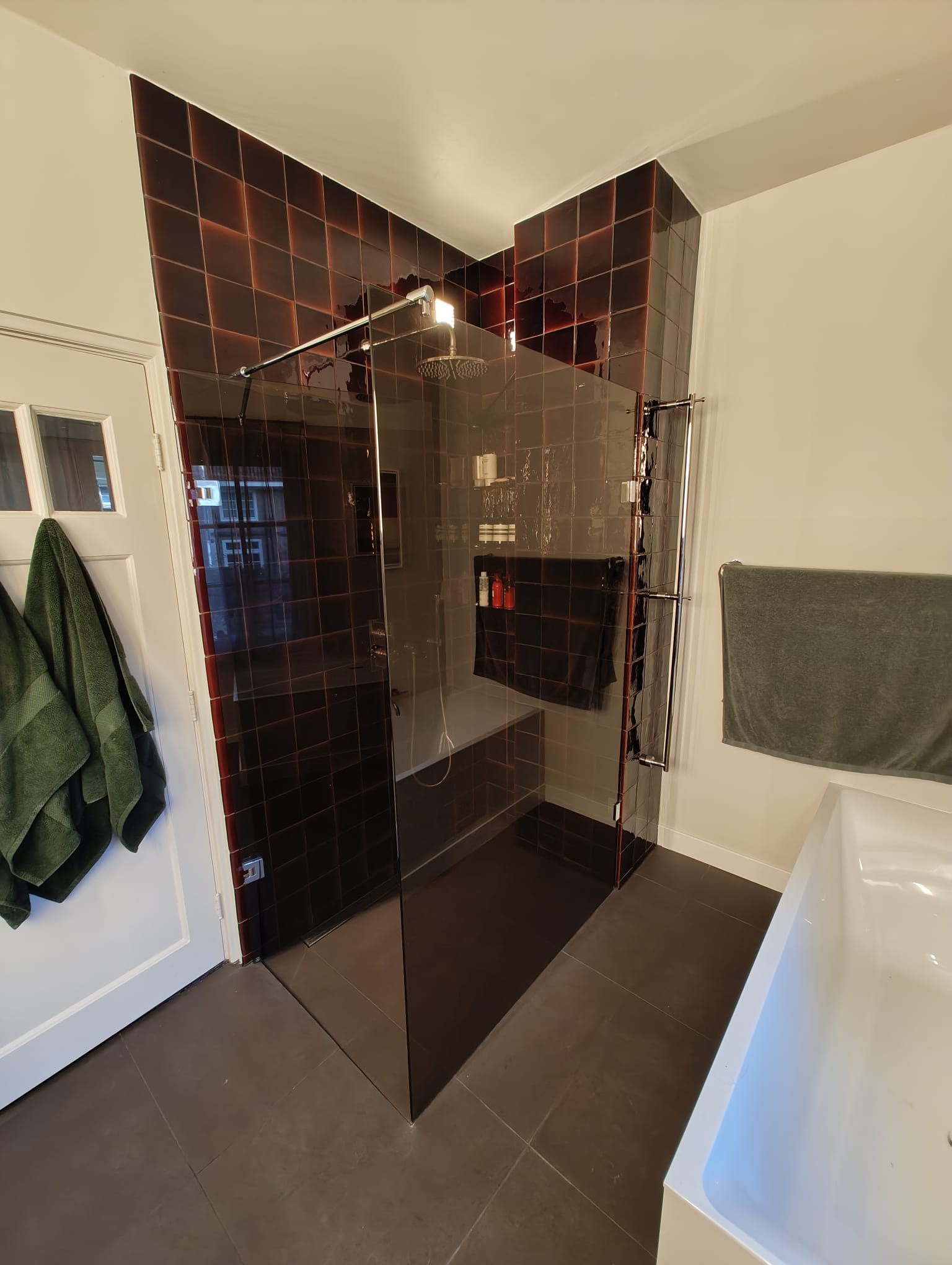 Walk-in shower with bench, full tile work and frameless glass enclosure