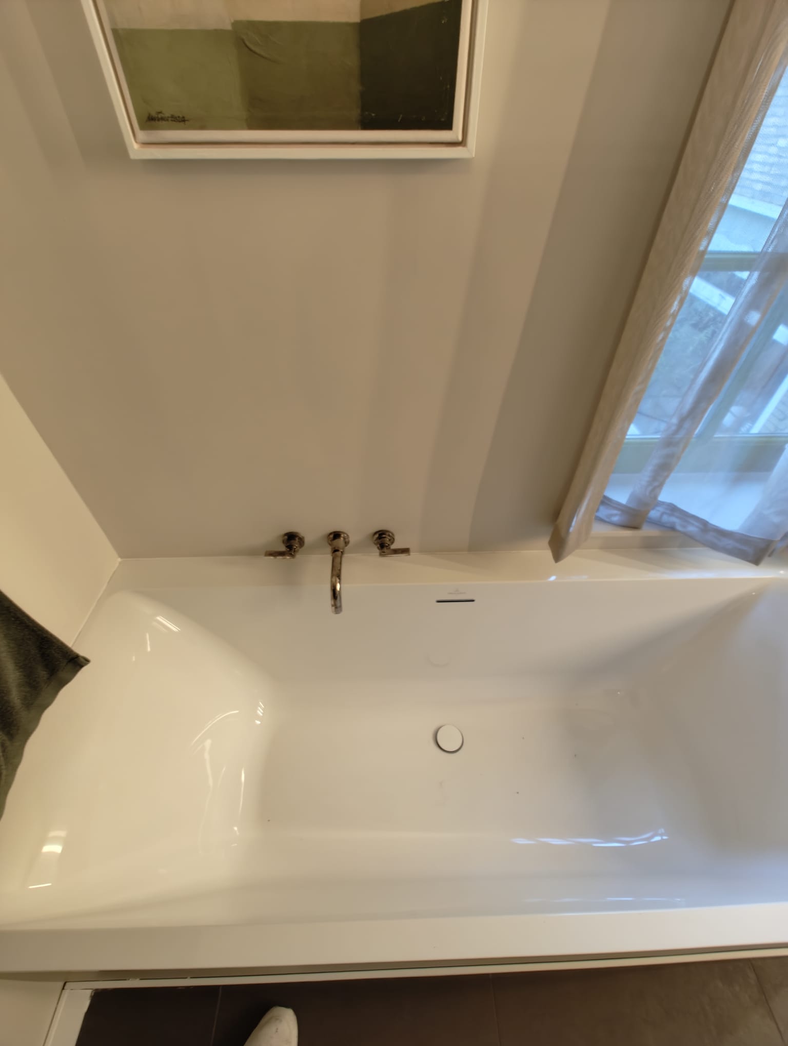 Freestanding bathtub with chrome wall taps