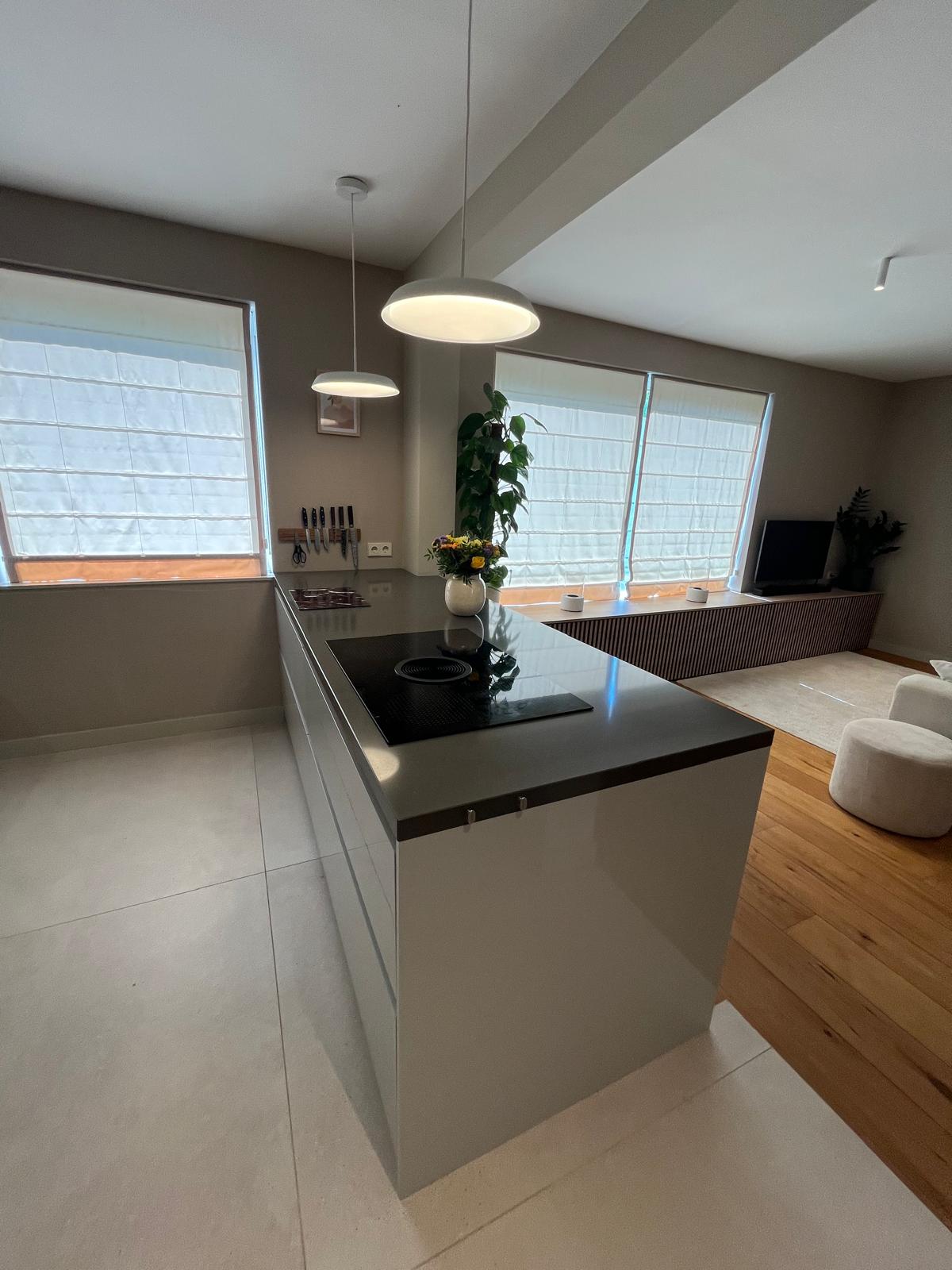 Open-plan kitchen and living area with marble island and slatted media console