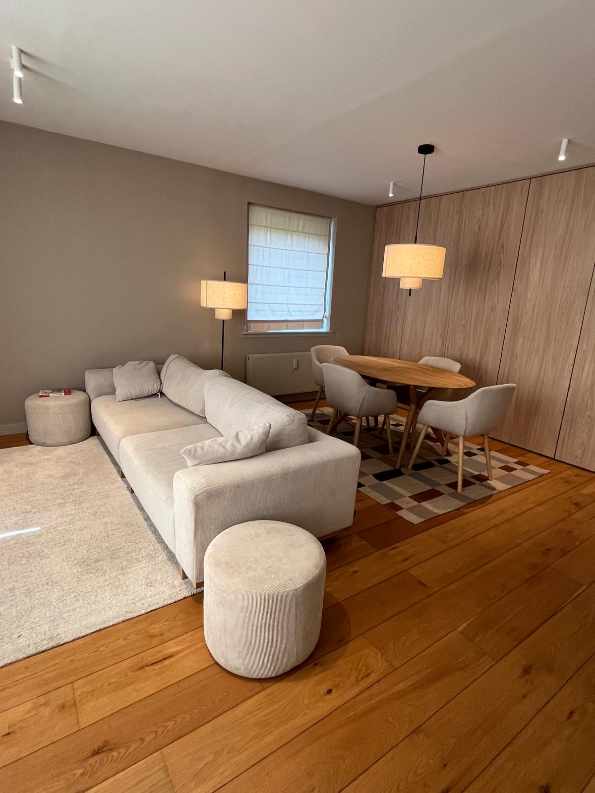 Open living and dining area with floor-to-ceiling oak wardrobes