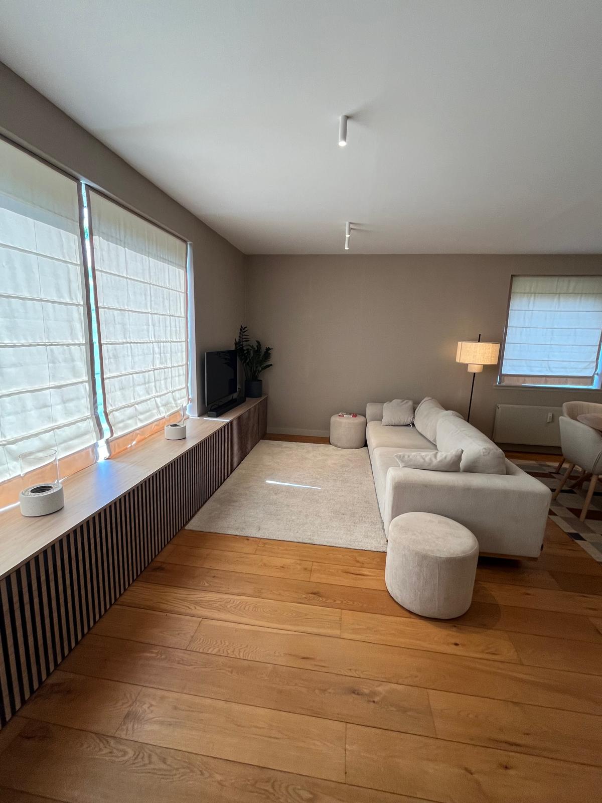 Living room with cream sofa and slatted window bench