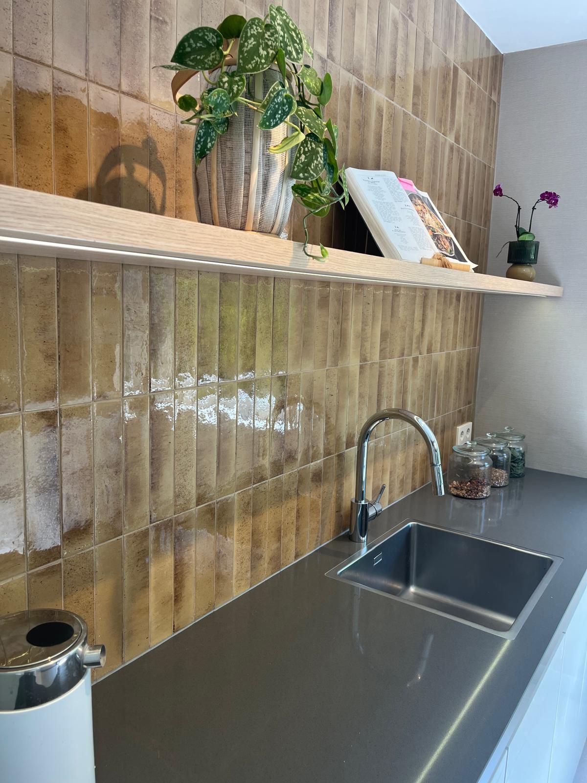 Kitchen sink zone with LED-lit floating shelf and glazed tile backsplash