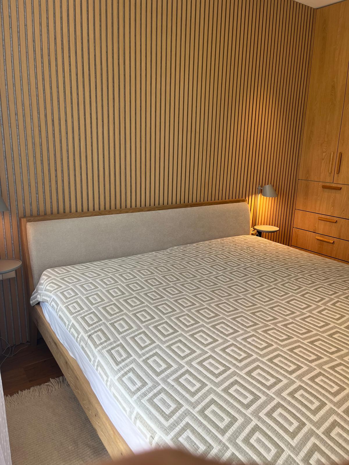 Bedroom overview with oak bed frame, wardrobe and reading lights